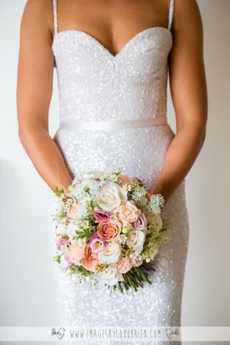A Woman in a White Dress is Holding a Bouquet of Flowers — Suncoast Flowers in Birtinya, QLD