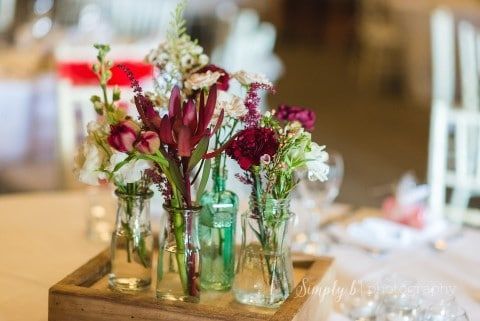 A Wooden Box Filled With Vases Filled With Flowers on a Table — Suncoast Flowers in Birtinya, QLD