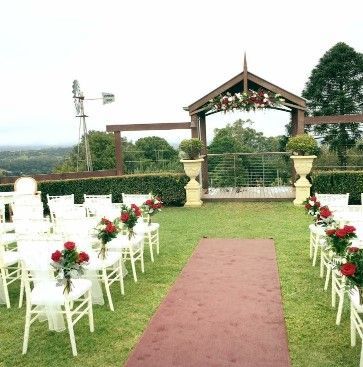 A Row of Chairs Are Lined Up in a Grassy Field for a Wedding Ceremony — Suncoast Flowers in Birtinya, QLD