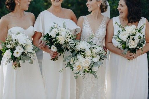 A Bride and Her Bridesmaids Are Standing Next to Each Other — Suncoast Flowers in Birtinya, QLD