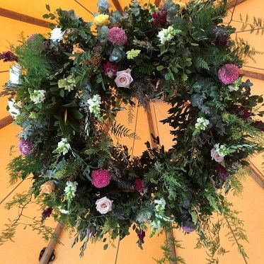 A Wreath of Flowers and Leaves is Hanging From the Ceiling of a Tent — Suncoast Flowers in Birtinya, QLD