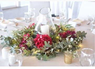 A Table With a Vase Filled With Flowers and a Candle on It — Suncoast Flowers in Birtinya, QLD
