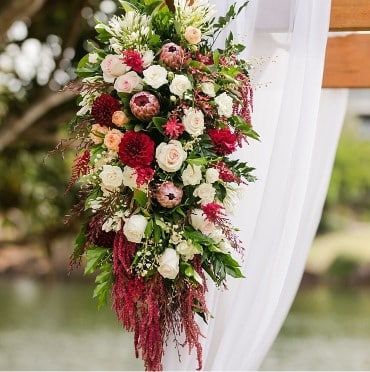 A Bunch of Flowers Are Hanging From a White Curtain — Suncoast Flowers in Birtinya, QLD