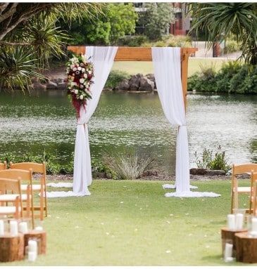 A Wedding Ceremony is Taking Place in Front of a Lake — Suncoast Flowers in Birtinya, QLD