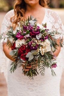 A Woman in a White Dress is Holding a Bouquet of Flowers — Suncoast Flowers in Birtinya, QLD