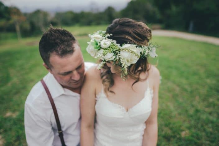 A Bride and Groom Are Posing for a Picture in a Field — Suncoast Flowers in Birtinya, QLD
