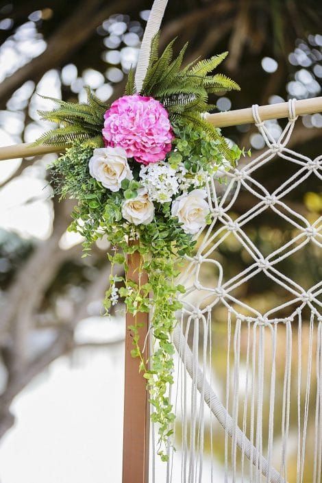 A Macrame Arch Decorated With Flowers and Greenery for a Wedding Ceremony — Suncoast Flowers in Birtinya, QLD