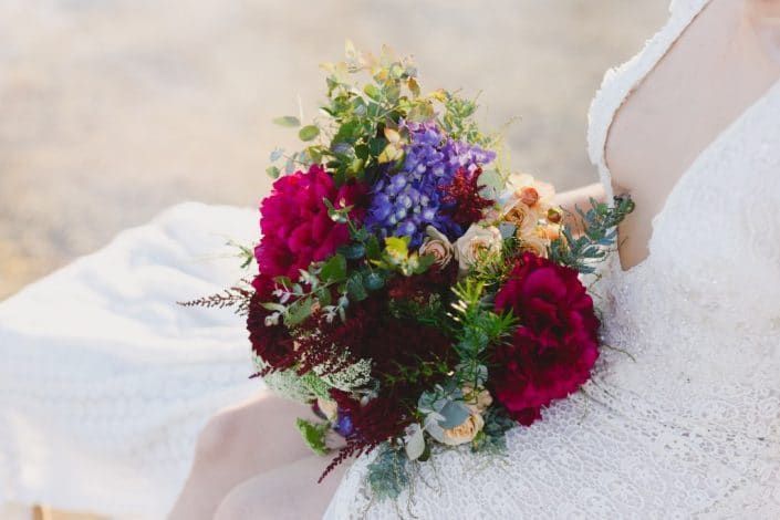 A Bride in a White Dress is Holding a Bouquet of Flowers — Suncoast Flowers in Birtinya, QLD