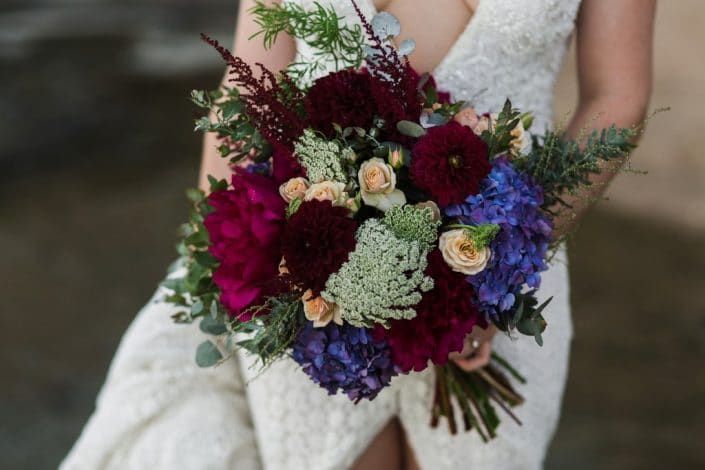 A Bride in a White Dress is Holding a Bouquet of Flowers — Suncoast Flowers in Birtinya, QLD