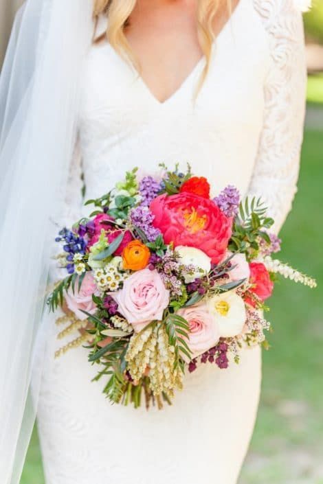 A Bride in a White Dress is Holding a Bouquet of Flowers — Suncoast Flowers in Birtinya, QLD