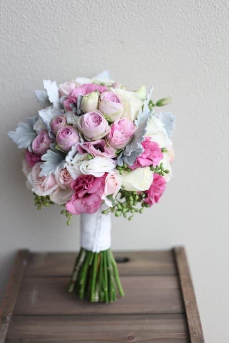 A Bouquet of Pink and White Flowers is Sitting on a Wooden Table — Suncoast Flowers in Birtinya, QLD