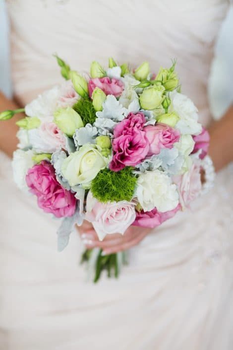 A Woman in a White Dress is Holding a Bouquet of Pink and White Flowers — Suncoast Flowers in Birtinya, QLD