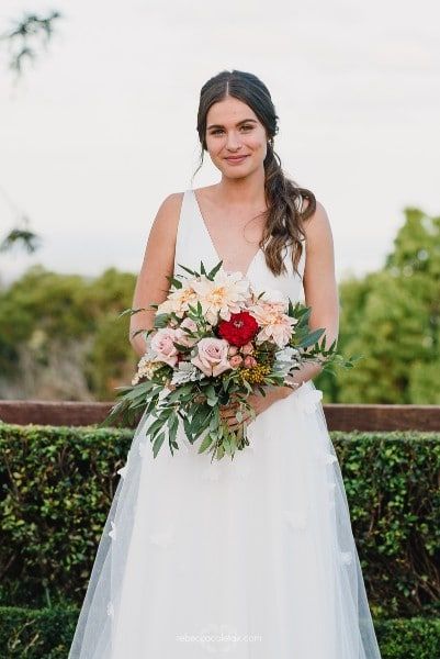A Bride in a White Dress is Holding a Bouquet of Flowers — Suncoast Flowers in Birtinya, QLD