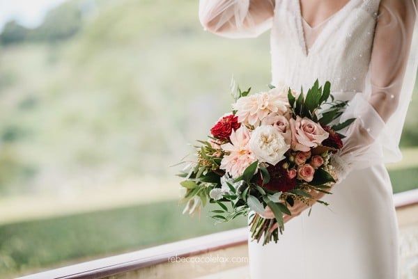 A Bride in a White Dress is Holding a Bouquet of Flowers — Suncoast Flowers in Birtinya, QLD