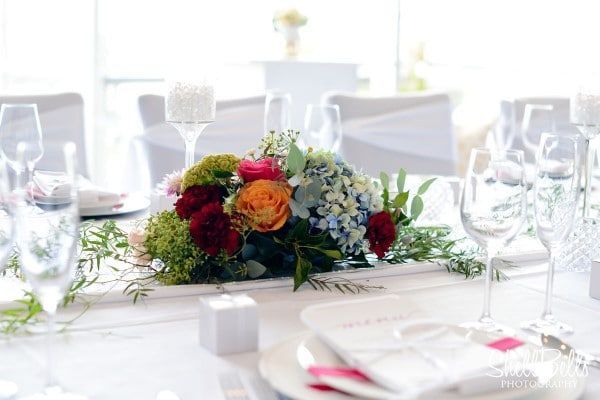 A Table With Plates, Glasses, and Flowers on It — Suncoast Flowers in Birtinya, QLD