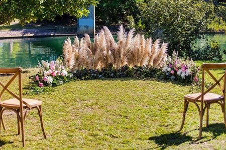 Two Chairs Are Sitting in the Grass in Front of a Floral Arrangement — Suncoast Flowers in Birtinya, QLD