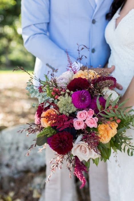 A Bride and Groom Holding a Bouquet of Flowers — Suncoast Flowers in Birtinya, QLD