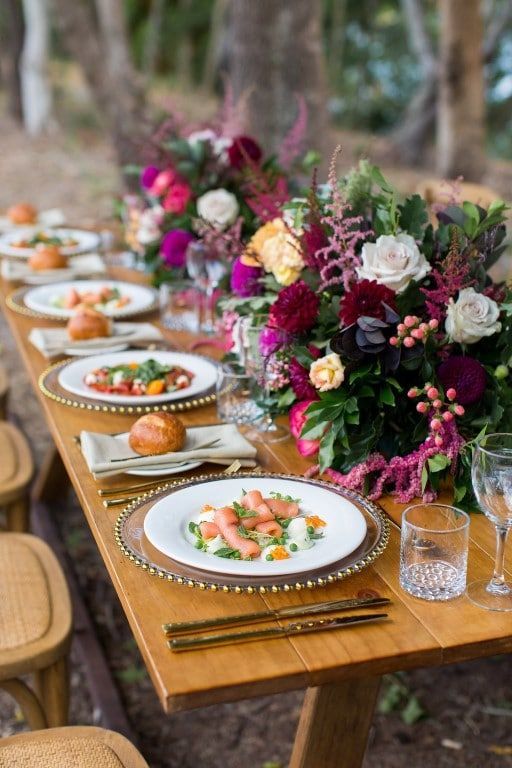 A Long Wooden Table With Plates of Food and Flowers on It — Suncoast Flowers in Birtinya, QLD
