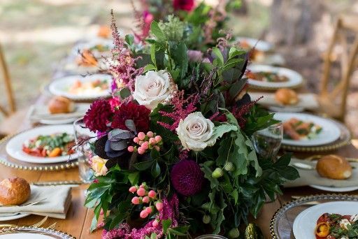 A Long Table With Plates of Food and Flowers on It — Suncoast Flowers in Birtinya, QLD