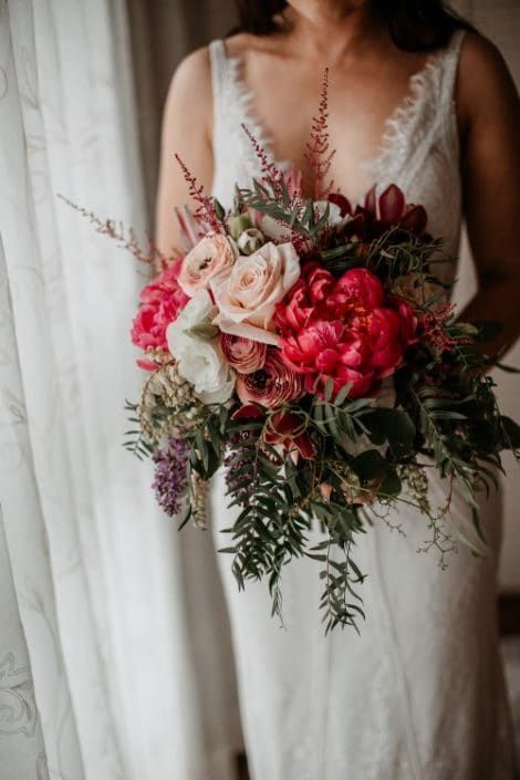 A Woman in a White Dress is Holding a Bouquet of Flowers — Suncoast Flowers in Birtinya, QLD