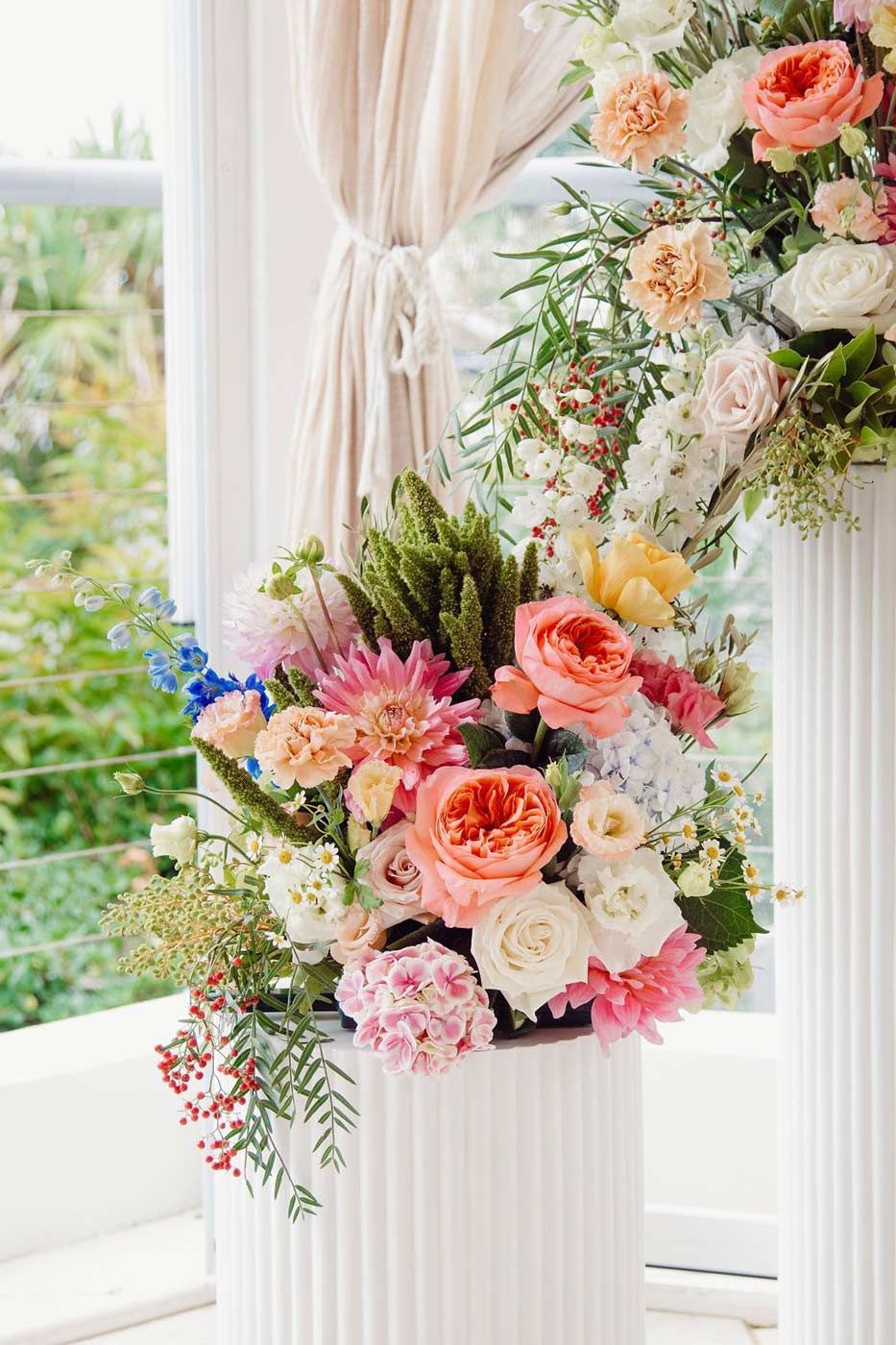 A Vase Filled With Flowers is Sitting in Front of a Window — Suncoast Flowers in Birtinya, QLD