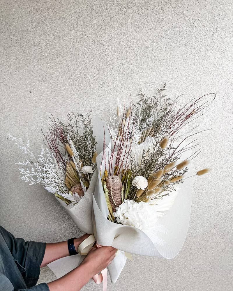 Hands Holding Bouquets of Dried Flowers