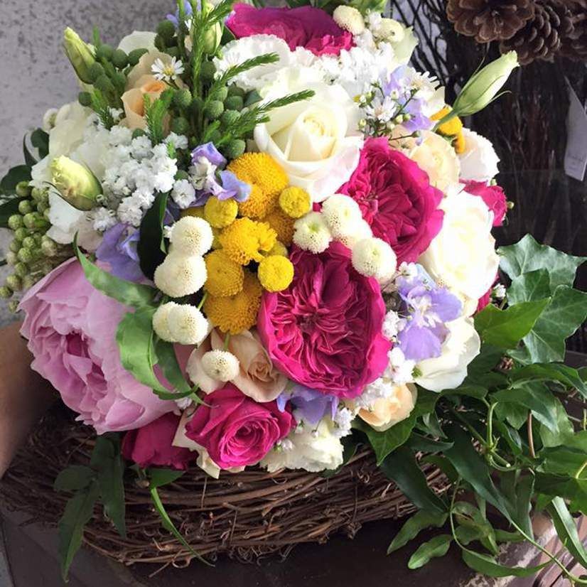A Person is Holding a Bouquet of Flowers in a Basket — Suncoast Flowers in Birtinya, QLD