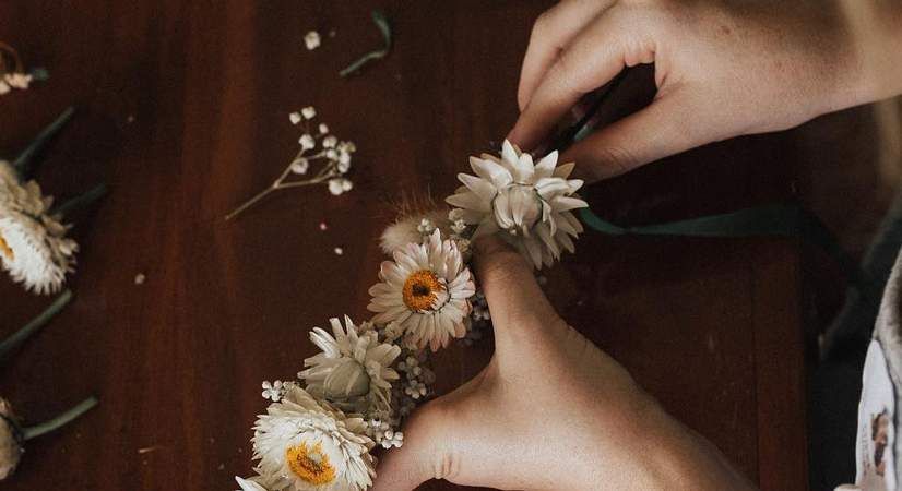 A Person is Making a Flower Crown on a Wooden Table — Suncoast Flowers in Birtinya, QLD