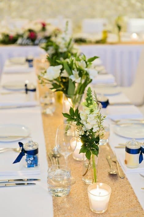 A Long Table With a Vase of Flowers and Candles on It — Suncoast Flowers in Birtinya, QLD