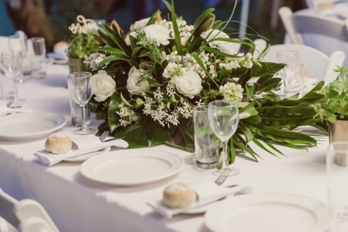 A Table Set for a Wedding Reception With Plates, Glasses, and Flowers on It — Suncoast Flowers in Birtinya, QLD