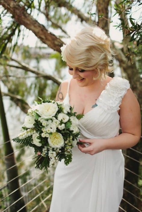 A Woman in a White Dress is Holding a Bouquet of White Flowers — Suncoast Flowers in Birtinya, QLD