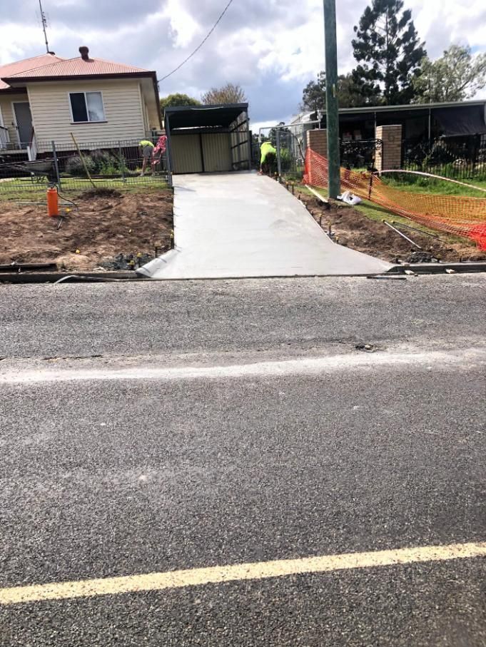 A Concrete Driveway Is Being Built In Front Of A House — Burgess Concreting In Kingaroy, QLD