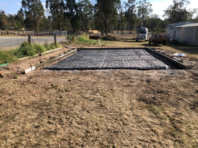 A Large Concrete Slab is Sitting on Top of a Dirt Field — Burgess Concreting In Nanango, QLD