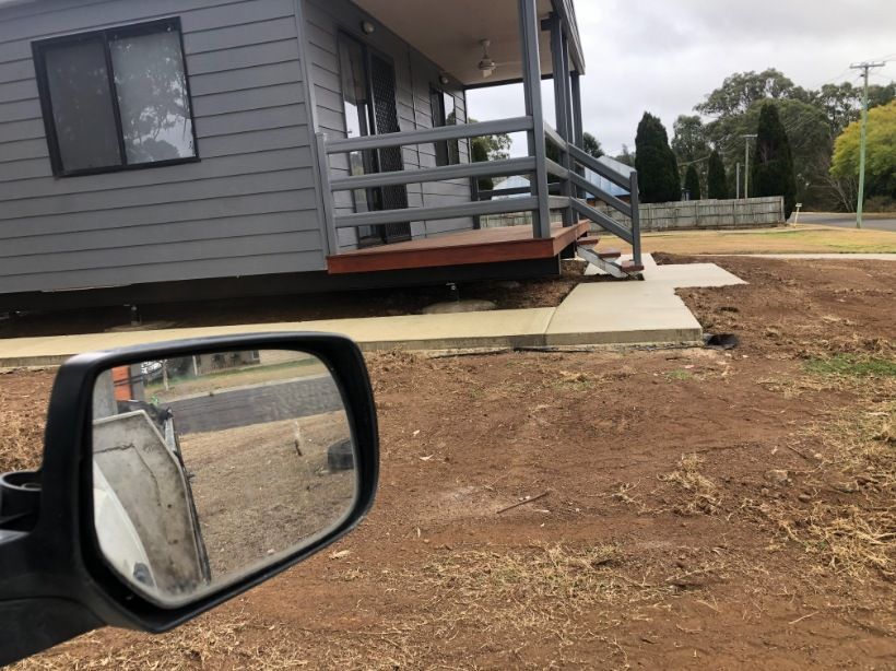 A Car is Parked in Front of a House in a Dirt Field — Burgess Concreting In Kingaroy, QLD