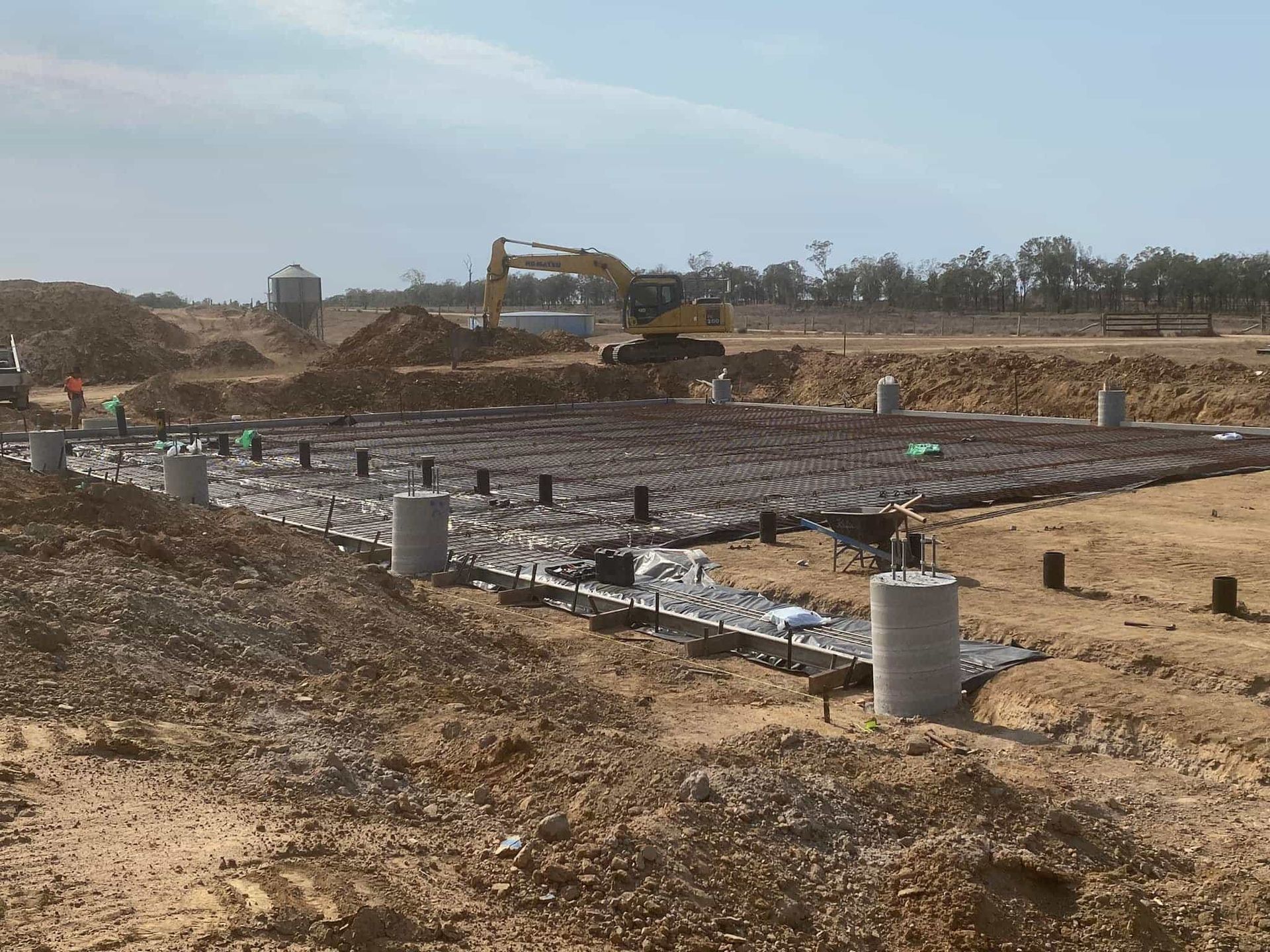 A construction site with a bulldozer in the background — Burgess Concreting In Kingaroy, QLD