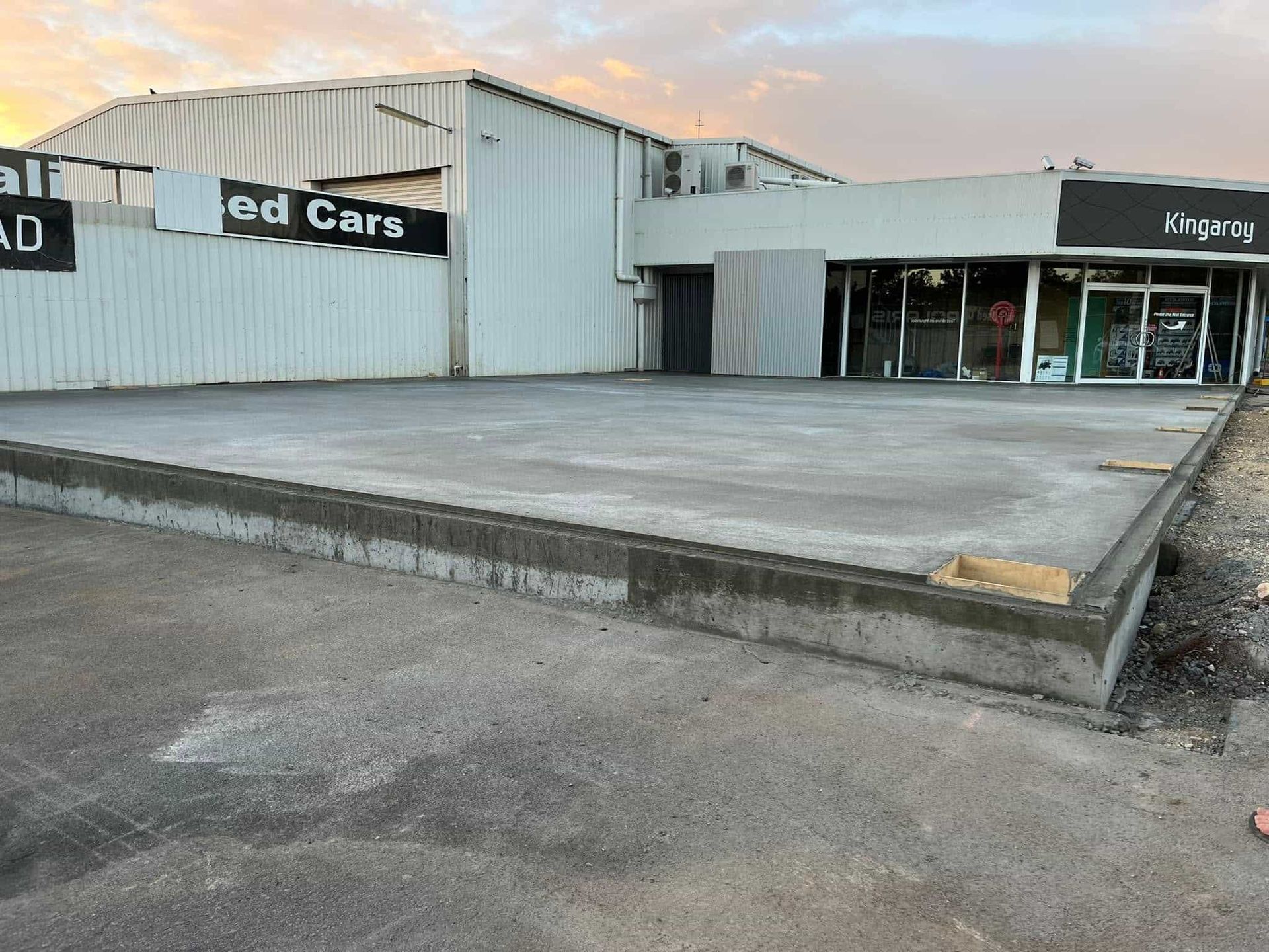 A large building with a concrete driveway in front of it. — Burgess Concreting In Kingaroy, QLD