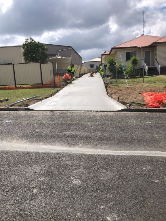 A Concrete Driveway is Being Built in Front of a House — Burgess Concreting In Kingaroy, QLD