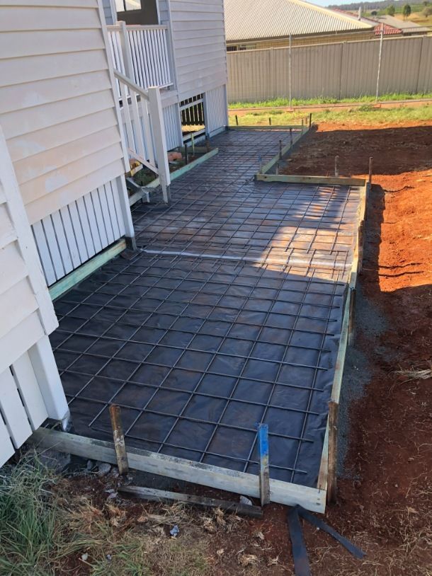 A Concrete Walkway is Being Built in Front of a House — Burgess Concreting In Kingaroy, QLD
