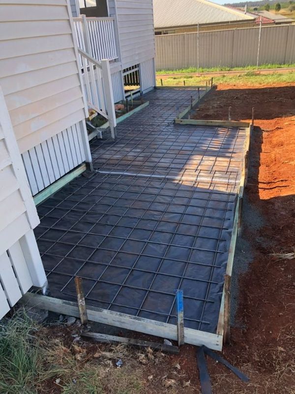 A Concrete Walkway is Being Built in Front of a House — Burgess Concreting In Kingaroy, QLD