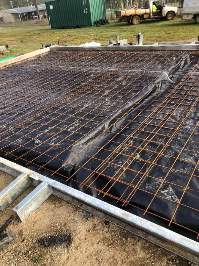 A Concrete Slab Is Being Built With A Truck In The Background — Burgess Concreting In Kingaroy, QLD