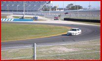 Car Shops — Images Of A White Car On A Race Track In Jacksonville, FL