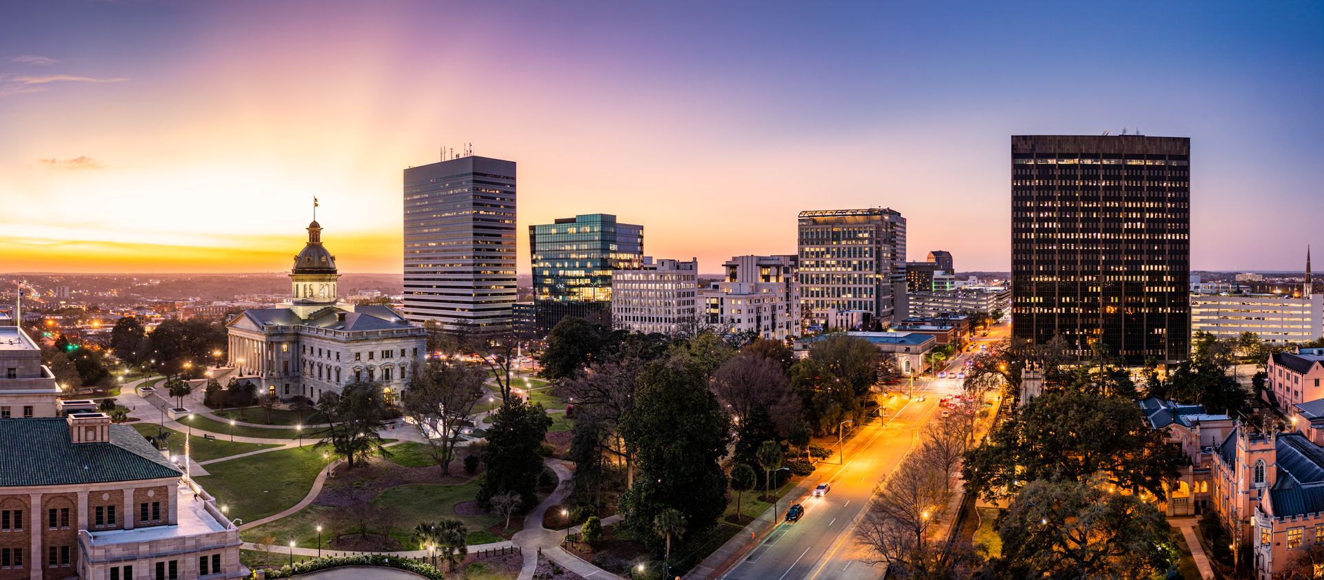An aerial view of a city skyline at sunset.