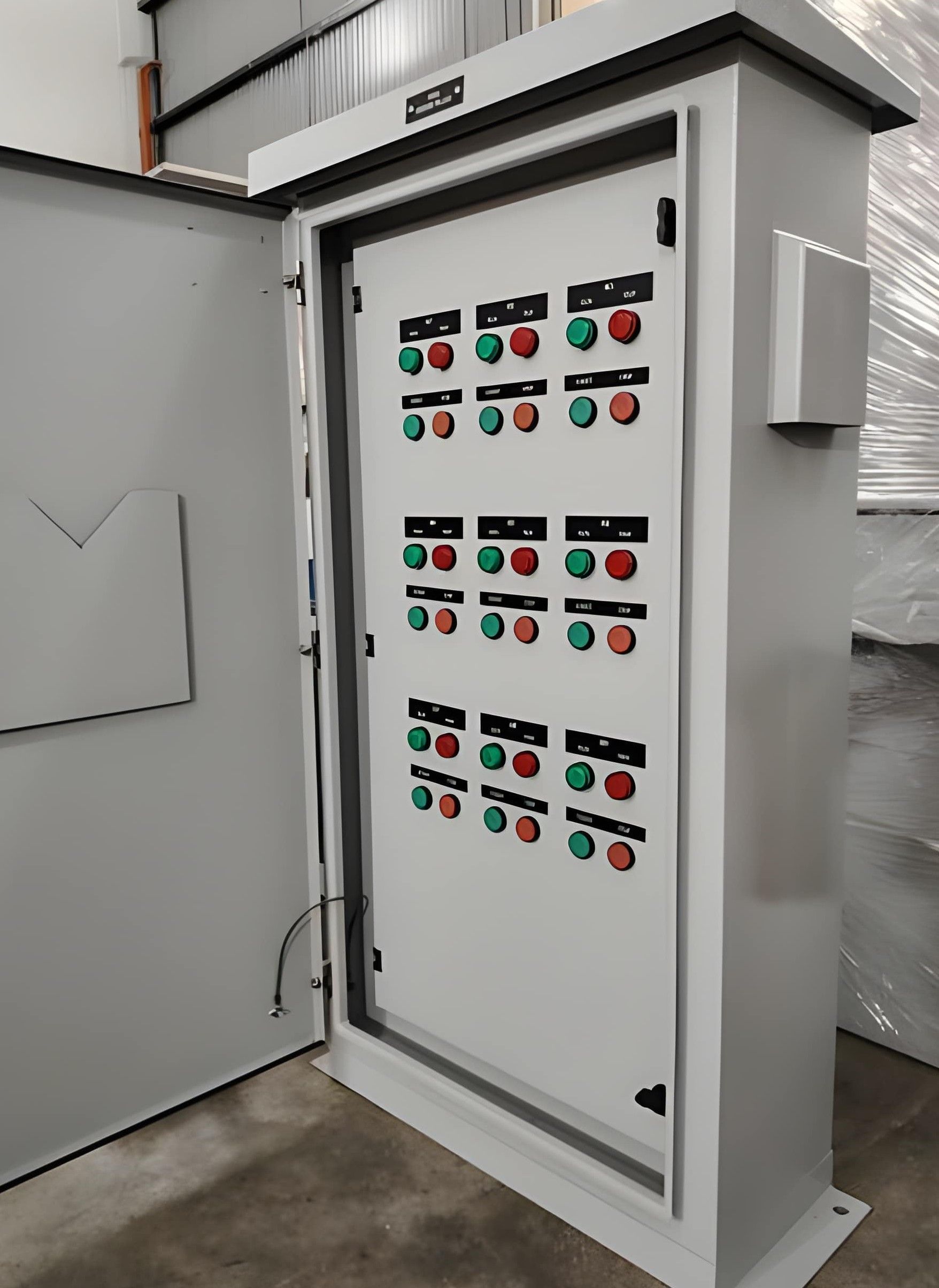 Large electrical panel cabinet in a clean, modern room with conduits and bright lighting.