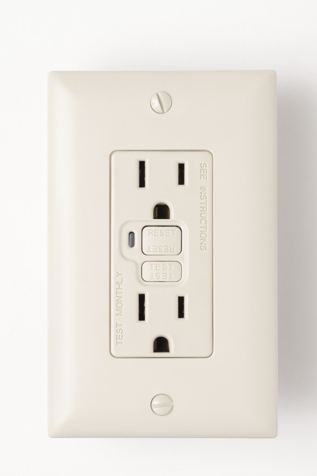 Beige GFCI electrical outlet with test and reset buttons on a white wall.