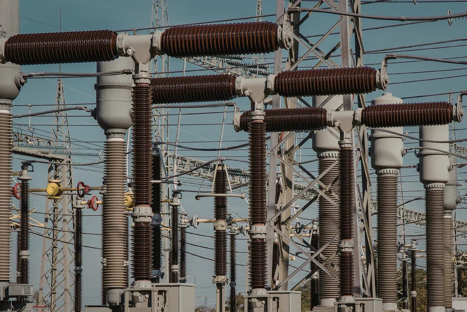 Two men are standing in an empty room with black walls