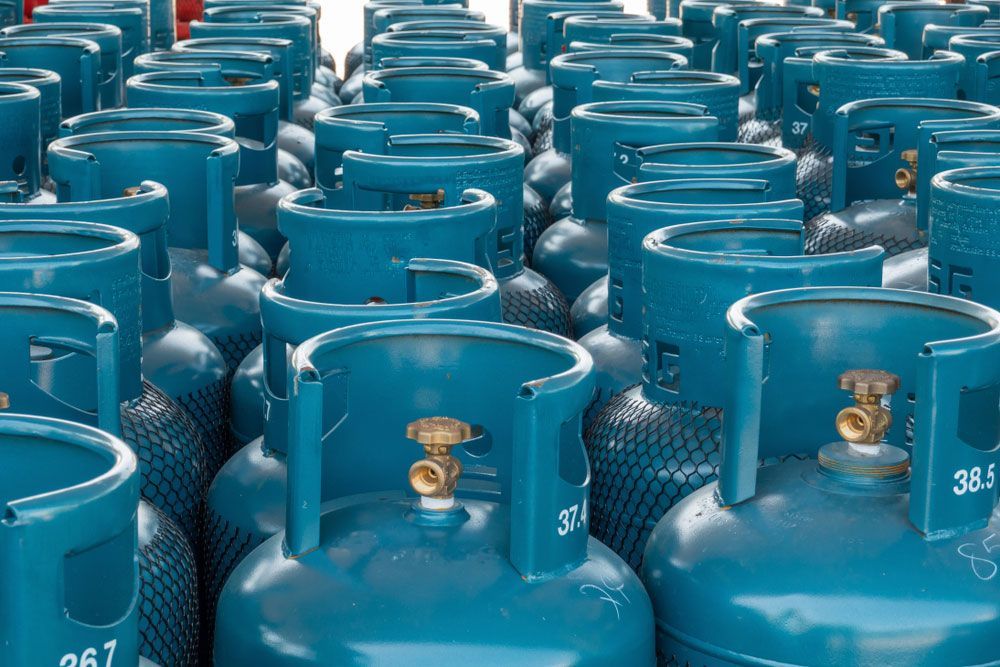 Bunch of Blue gas Cylinders are Lined up in a row — LPG Swap & Go in Dayboro, QLD