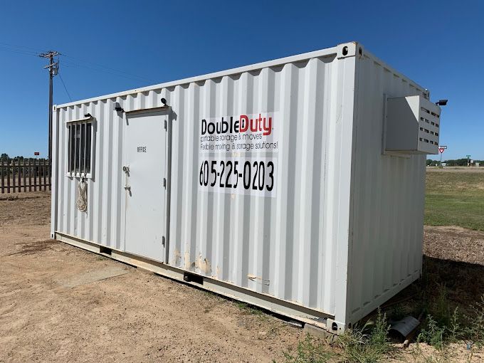 A white shipping container with double duty written on it