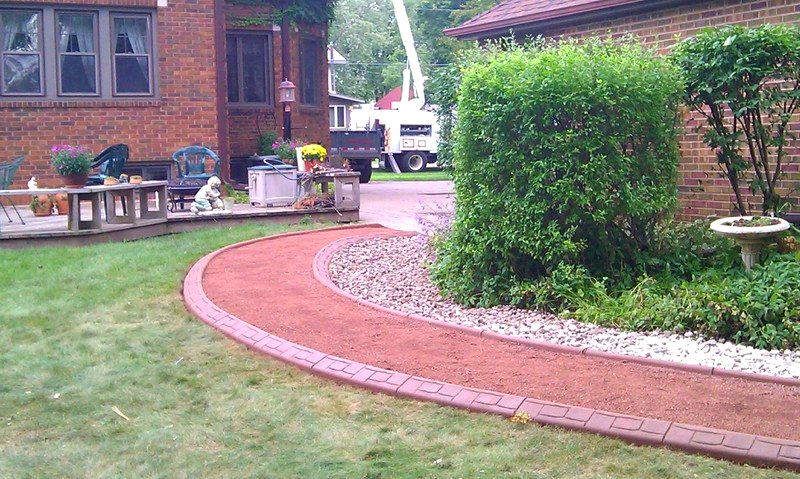 A brick walkway in front of a brick house