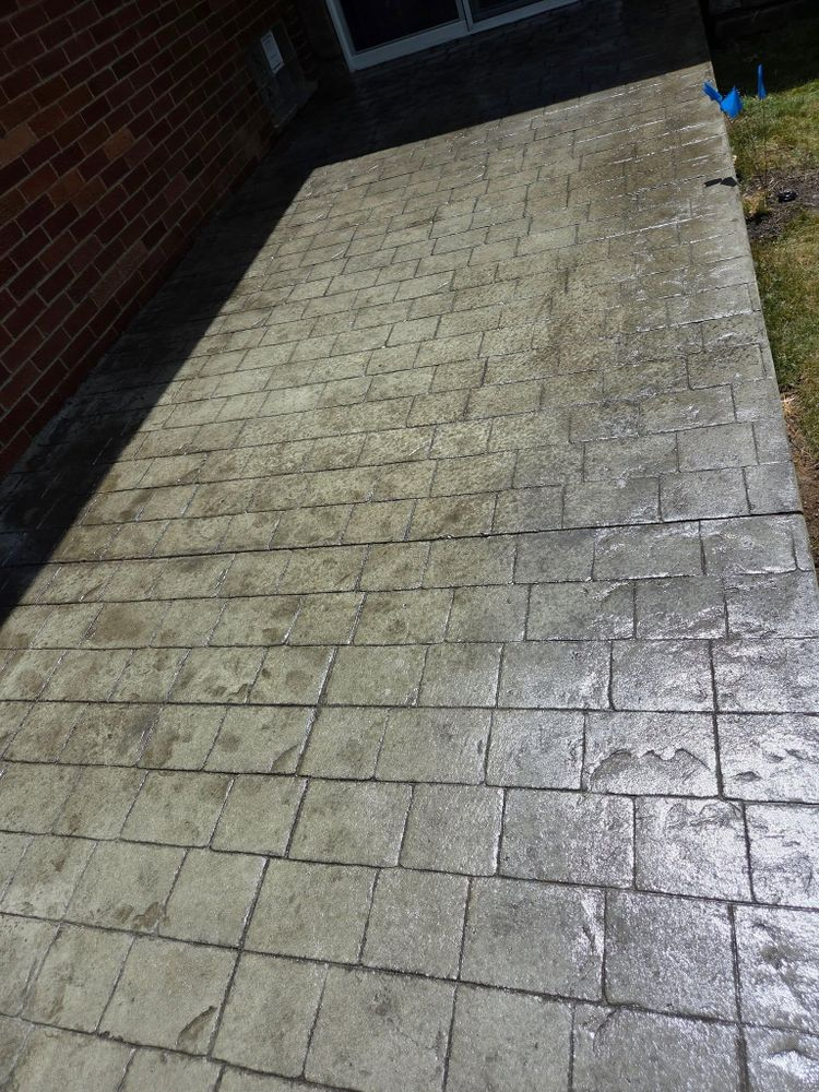 A brick walkway with a brick building in the background