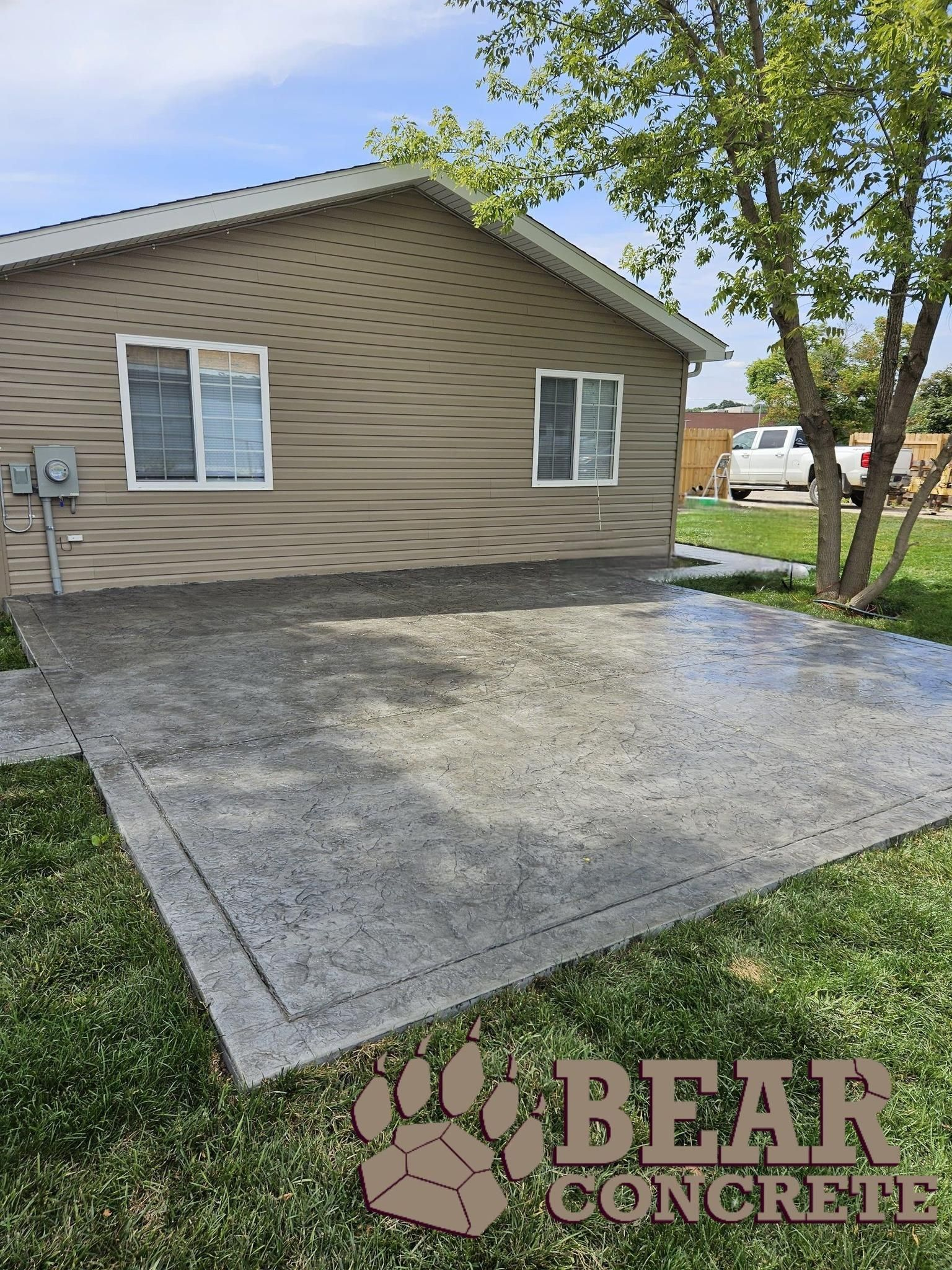 A house with a concrete driveway in front of it